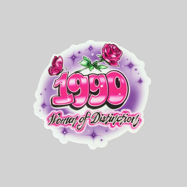 May include: A pink and purple sticker with the year 1990 in large, bubble letters. The sticker also features a pink rose with a green stem and a pink butterfly. The text "Women of Distinction" is written in a cursive font below the year.