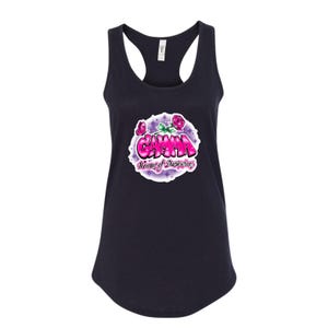 May include: A black tank top with a pink and purple graphic of the word "Gamma" with the words "Women of Distinction" underneath. The graphic is surrounded by a circle of stars and roses.