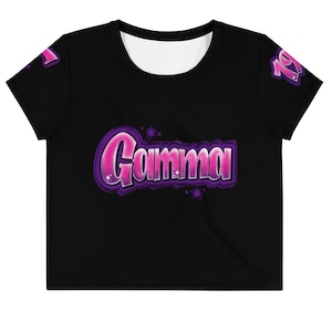 May include: Black crop top with a pink and purple "Gamma" graphic with stars.