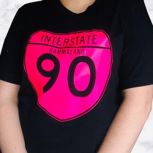 May include: Black t-shirt with a pink heart-shaped interstate highway sign that says "INTERSTATE GAMMALAND 90".