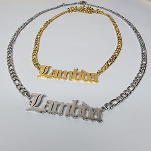 May include: Two gold chains with a silver chain layered on top. The gold chains have a pendant with the word "Lambda" in a gothic font. The silver chain has a pendant with the word "Lambda" in a gothic font.