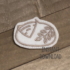 May include: A white felt patch with a brown embroidered design of a stylized leaf with a seed pod. The patch has a stitched edge.