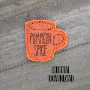 May include: Orange felt applique of a coffee mug with the text "Pumpkin Spice" in brown embroidery thread.