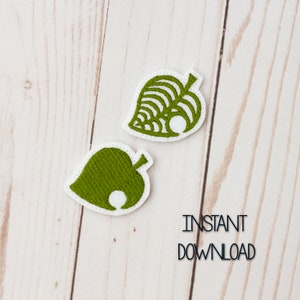 May include: Two green embroidered patches shaped like a leaf with a white outline. The leaf has a pattern of lines and a white circle in the center. The text "INSTANT DOWNLOAD" is printed below the patches.