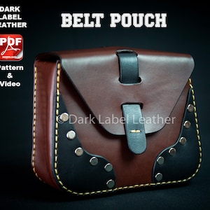 May include: A brown leather belt pouch with a black flap and a black leather strap. The pouch has a yellow stitch around the edges and silver rivets. The text "Dark Label Leather" is printed on the flap.