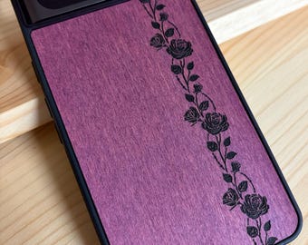 May include: A black smartphone case featuring a purple wood-grain back panel with a vertical engraved design of climbing roses and thorns. The word alto is printed in small black letters at the bottom of the purple panel, near the edge.