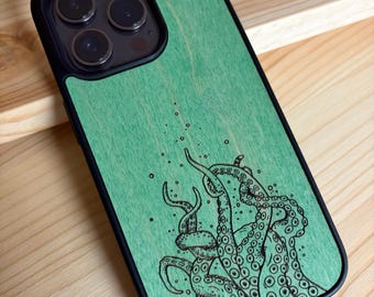 May include: A smartphone case featuring a light green wood grain finish with a black ink illustration of octopus tentacles reaching upward. The design includes small bubbles and detailed suction cups on the tentacles, set against a smooth surface.