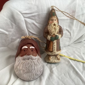 Two Saint Nicolas Christmas ornaments, one made of Mount St. Helen ash/clay