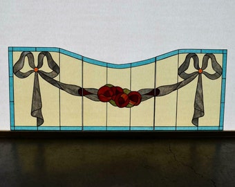 May include: A stained glass window panel with a curved design featuring two gray bows with orange centers and a garland of red and green roses.