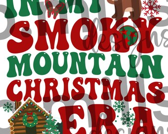 May include: Red and green text on a white background reads "In My Smoky Mountain Christmas Era". A small cabin with a wreath on the door is in the bottom left corner. A brown bear wearing a Santa hat is in the top right corner.