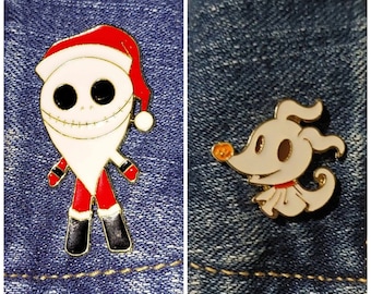 May include: Two enamel pins featuring characters from the movie The Nightmare Before Christmas. The first pin is a white, red, and black Santa Claus version of Jack Skellington. The second pin is a white Zero the ghost dog.
