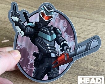Op de afbeelding: Een zwart en turquoise personage met een rood vizier en een kettingzaag, tegen een roze en paarse achtergrond. Het personage steekt zijn middelvinger op. De sticker zegt "HEADSPACE GRAPHICS" onderaan.