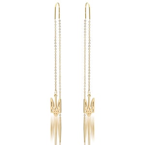 May include: Gold-tone earrings with a dangling trident charm. The earrings are made of a thin chain and have a hook closure.