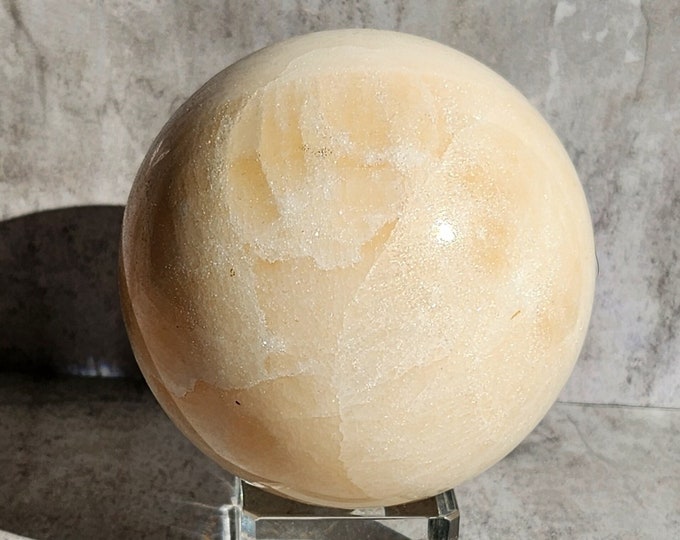 Ivory Calcite Ball: Calming energy, promotes emotional balance and clarity, subtly warm with soft, natural radiance.