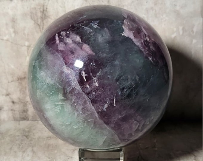 Rainbow Fluorite Sphere Purple and Green Layers: Helps with concentration, clear thinking and energetic protection. Promotes calmness and focus
