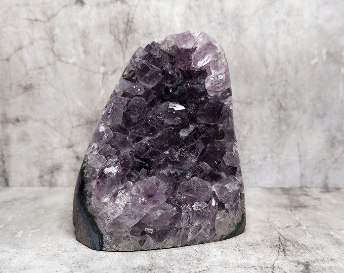 Amethyst Geode: A serene purple oasis, radiates peace and spiritual growth. Perfect harmony for positive energy in your space.