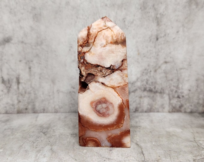 Red Agate with geode opening and unique bands. For strength and balance, with a warm, grounding appearance. Raw and polished in one.