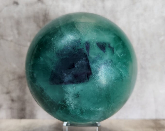 Green fluorite sphere, intense colors and flash inclusions. A unique piece that brings balance and clarity to any space.