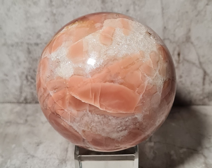 Soft pink Mangano Calcite sphere: promotes love, peace and healing – a subtle yet powerful companion for heart chakra work.