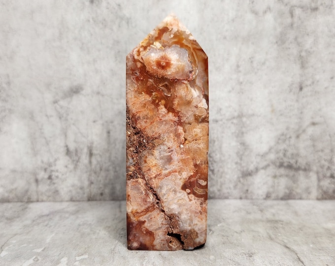 Red Agate with rough inclusions and earthy layering. Brings strength, stability and grounded peace. Each side shows unique patterns.