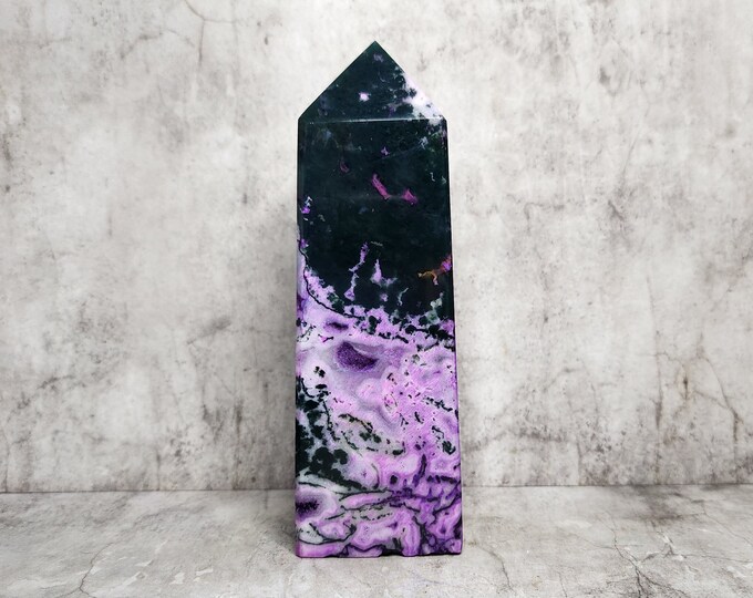 Purple moss agate, colored for aesthetics, contains green inclusions. The color is not natural, but adds visual appeal.