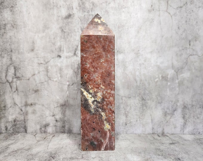 Rhodonite: Embraces love and self-development. Promotes emotional well-being and expression. Brings harmony to relationships with gentle strength.