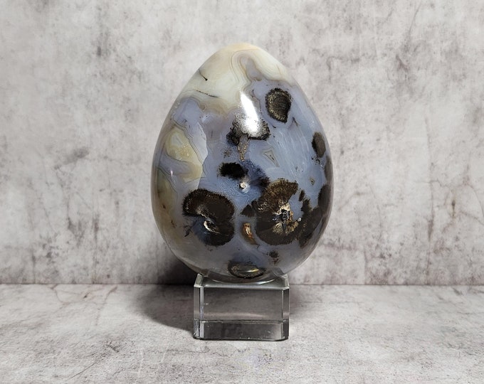 Dendritic Agate Egg: White-creamy stone that promotes spiritual growth, balance, and helps manifest abundance and harmony.