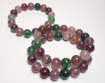Strawberry quartz in multiple colors, ranging from pink-red and sometimes even green and yellow. It promotes love, joy and emotional balance.