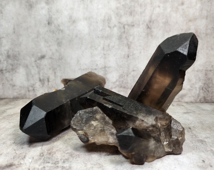 Raw Smoky Quartz cluster with deep hue. Works grounding, protective and helps release tension. Perfect for focus, clarity and balance.