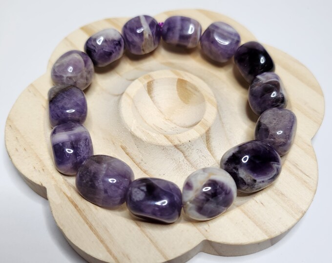 Chevron Amethyst: A purple gemstone with white V-shaped patterns. Calming and protective, it promotes spiritual growth and intuition.