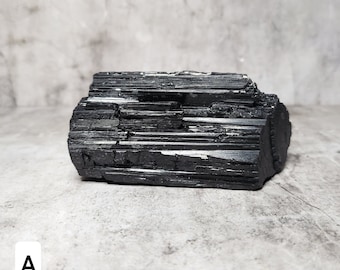 Raw Black Tourmaline: An unpolished gemstone that protects and grounds. Absorbs negative energy and promotes emotional stability.