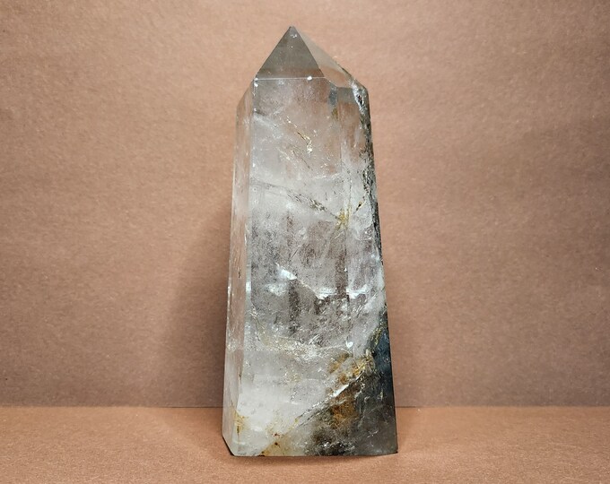 Rock crystal with earthy inclusions. Helps with purification, peace and intention. The light reveals a miniature landscape in crystal.