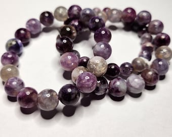 Sugilite: Purple Emerald in Mica, deep purple colors with chrome. Promotes intuition, love and helps to release negative energy