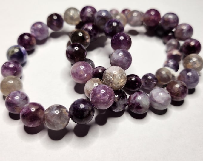 Sugilite: Purple Emerald in Mica, deep purple colors with chrome. Promotes intuition, love and helps to release negative energy