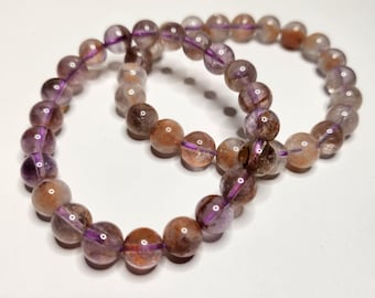 Super 7, also known as Melody Stone: amethyst, smoky quartz, clear quartz, rutile quartz, cacoxenite, goethite and lepidocrite.