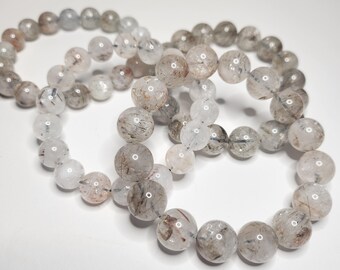 Red-silver Rutilated Quartz: Clear and white rock crystal to dark gray, brown smoky quartz, filled with silver-colored, red rutile needles.