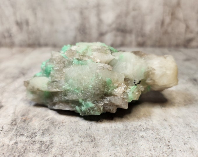 Raw emerald in white matrix. Strengthens love, trust and inner peace. Rare combination with calm, natural appearance.