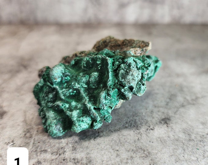 Raw Malachite: Powerful stone for transformation and protection. Helps absorb negative energy and promote emotional growth.