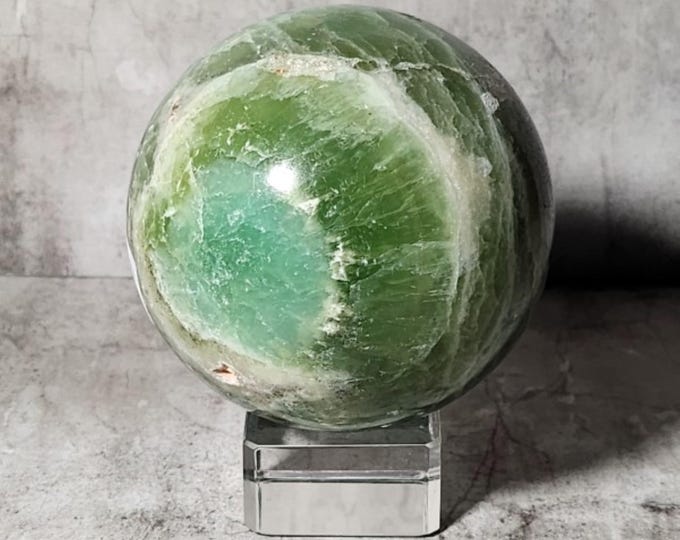 Green Onyx ball that brings peace, focus and strength. Beautifully polished with natural bands - an energetically powerful eye-catcher.