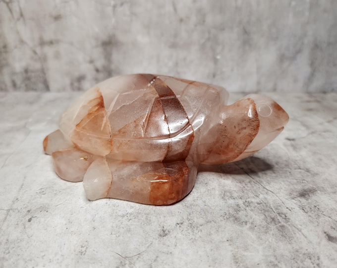 Fire quartz turtle is quartz with red hematite inclusions. It promotes vitality, passion, creativity and emotional balance.