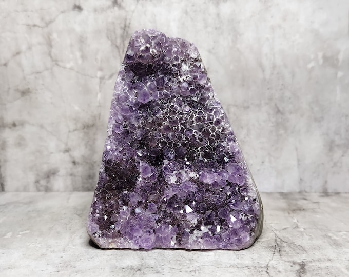 Amethyst Geode: Harmonious purple ensemble, radiates peace, stimulates spiritual growth. Enchanting addition for positive energy.