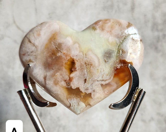 A Flower Agate heart radiates beauty with its unique flower-like patterns. Promotes inner growth and brings harmony to the heart.