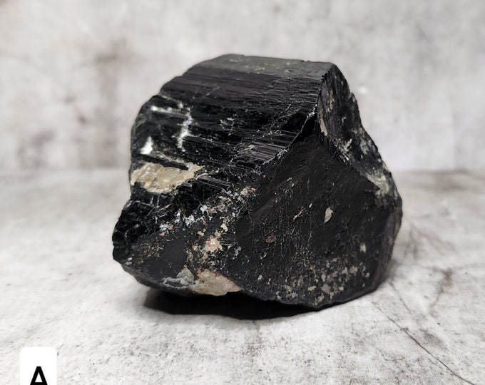 Raw Black Tourmaline: An unpolished gemstone that protects and grounds. Absorbs negative energy and promotes emotional stability.
