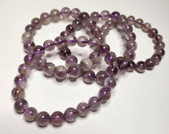 Amethyst phantom: Interwoven with other minerals. This creates a layered effect with beautiful different colors and inclusions.
