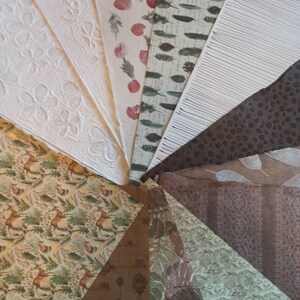May include: A collection of patterned papers in various colors and designs, including floral, geometric, and animal prints. The papers are arranged in a fan shape, with the tips of the papers meeting in the center.