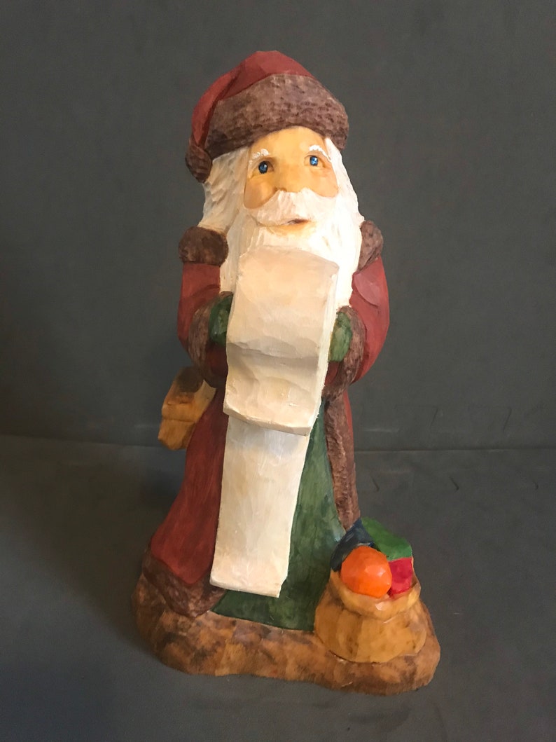 and a bag of presents Santa with list