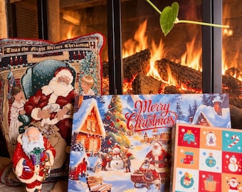 May include: A collection of Christmas-themed items including a tapestry pillow with Santa Claus and the text 'Twas the Night Before Christmas', a standing Santa figurine, a rectangular sign with a winter scene and 'Merry Christmas', and a grid-patterned box.