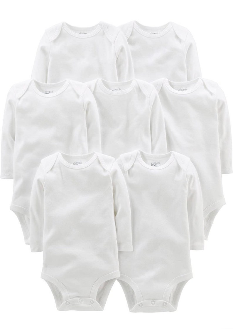 May include: A set of seven plain white long-sleeve bodysuits for infants. Each garment features a round neckline, expandable shoulders for easy dressing, and a snap-button closure at the bottom. The fabric is a solid, opaque white throughout.
