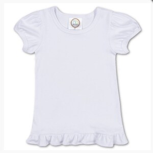 May include: White short-sleeved t-shirt with a ruffled hem. The shirt has a small tag with the letters "BB" on it.
