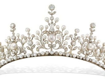 May include: A delicate pearl and diamond tiara with a floral design. The tiara is made of silver and features a row of pearls along the bottom edge.